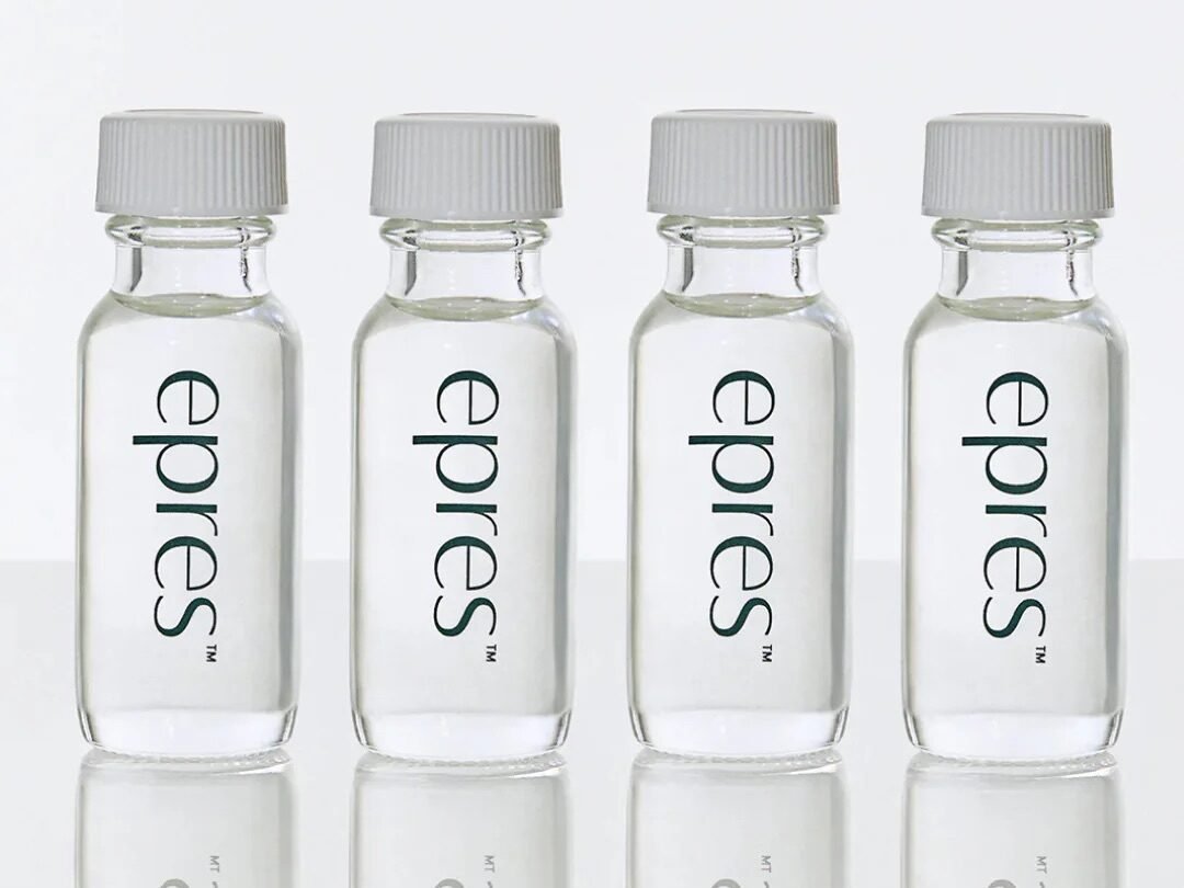 Four epres Bond Repair Concentrate refill vials with clear glass bottles and white caps on a white reflective surface
